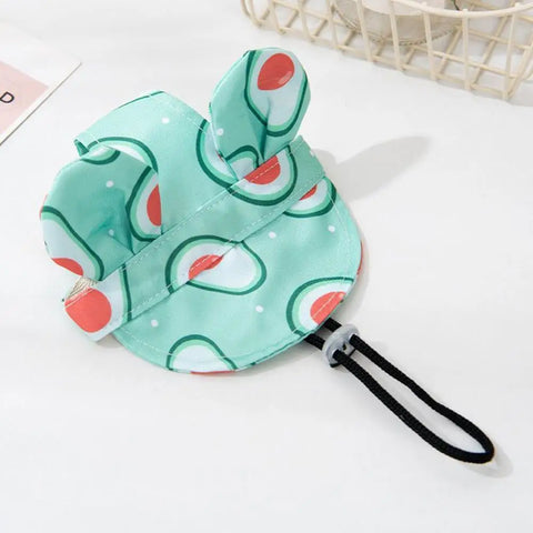 Small dog wearing adjustable bucket hat with ear holes and flower stripes
