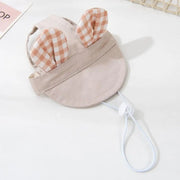 Puppy wearing soft fisherman hat with ear holes for sun protection
