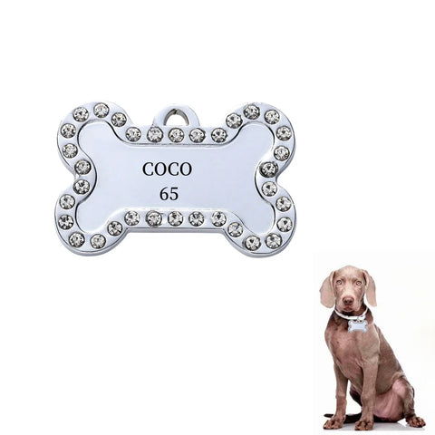 Personalized pet ID tag in bone shape with rhinestones, engraved with the name 'COCO' and number '65'.